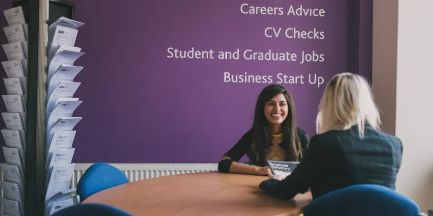 Graduate receiving advice and support at university.