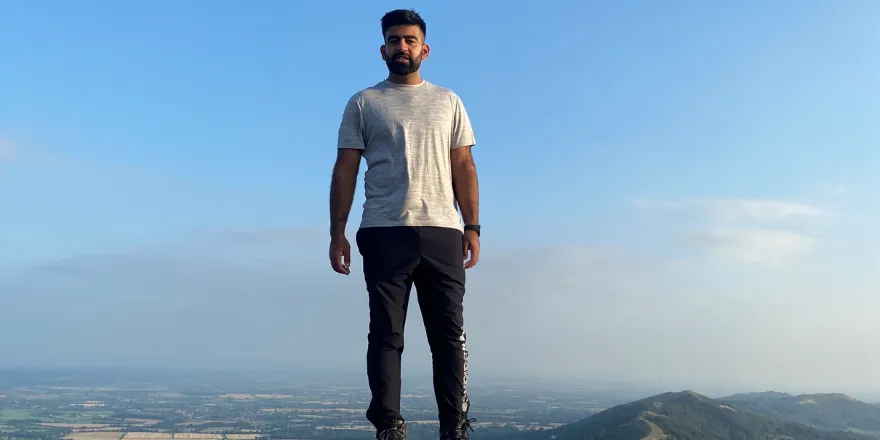 Man standing on top of a hill.