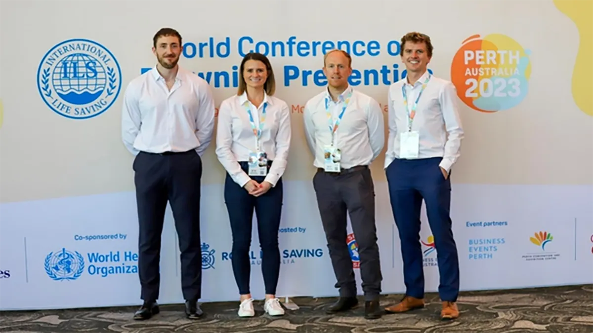 Four people in white shirts and black trousers posing at the Water Conference in Perth, Australia..