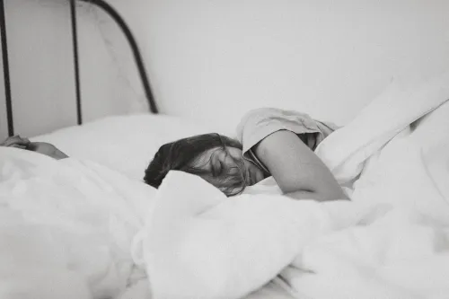 Black and white photo of person sleeping.