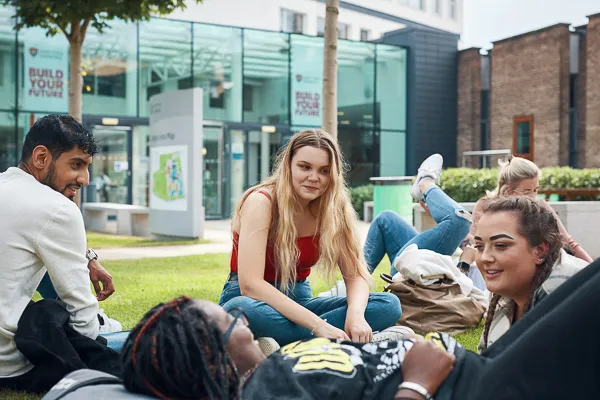 Students relaxing at Main Campus Entrance.