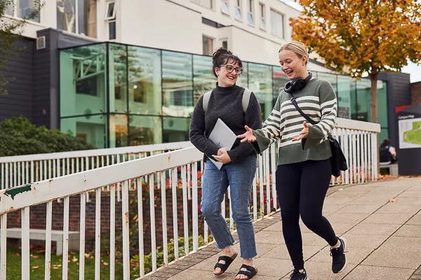 Students walking outside Main Campus entrance.