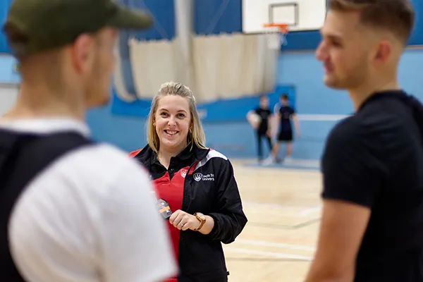 Lecturer speaking to students in a practical session.