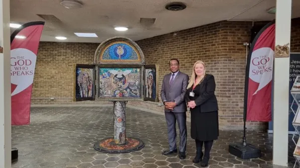 Charles Egbu and Ann Marie Mealey stood next to the 'Little Bits of God' Mosaic.