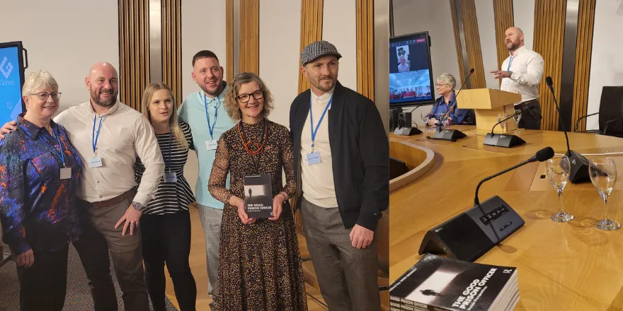 A group of people posing for a photo in a wood-panelled room..