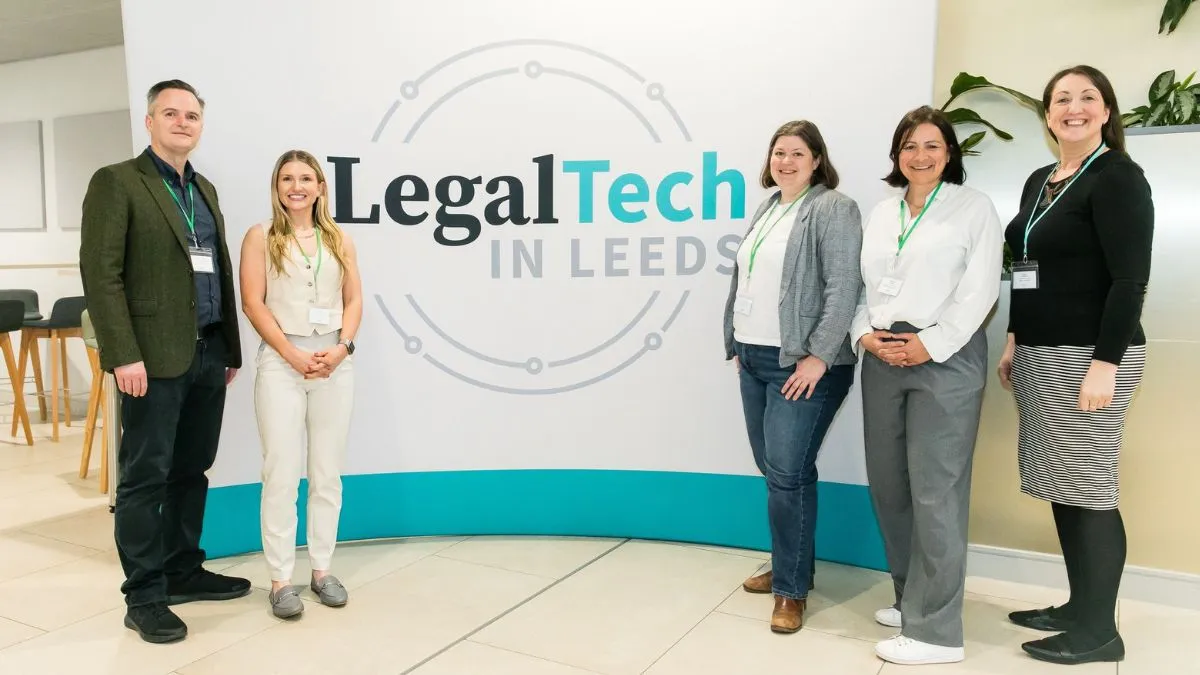 Five people stand in front of a background that says Legal Tech in Leeds.