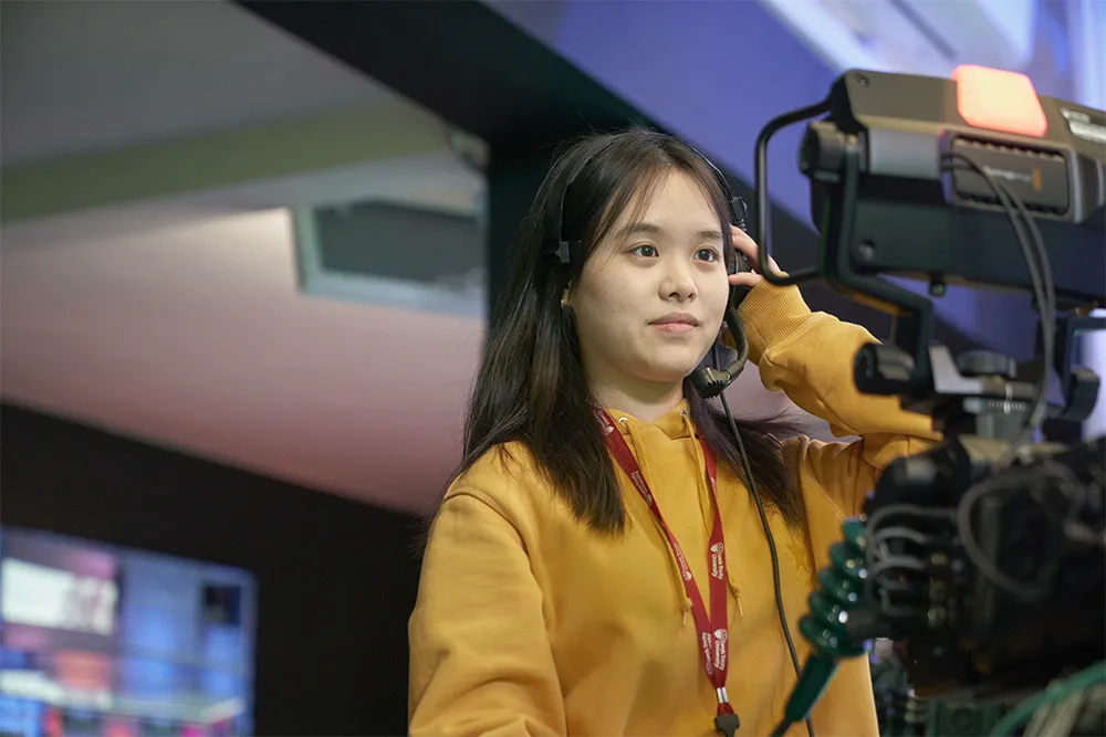 Student controlling a broadcasting camera in the Media Centre.