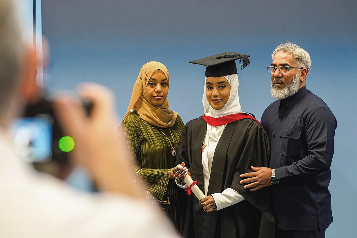 Family getting a photograph at a graduation ceremony.