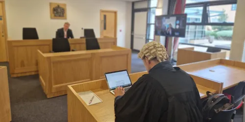 A Leeds Trinity student sits in front of a judge during a mooting competition.