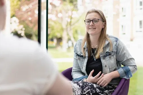 Health and Social Care student Jemma Ryley sits in the Atrium at Main Campus