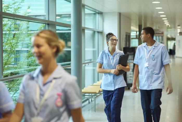 Nurses walking along a corridor..